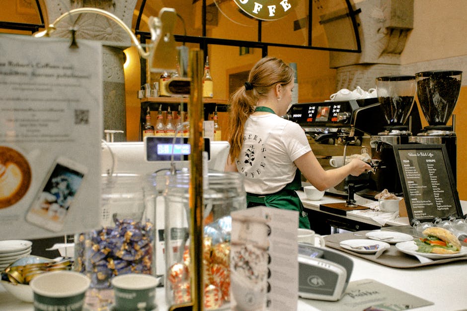Barista making coffee in a cozy cafe, showcasing a warm and inviting atmosphere.